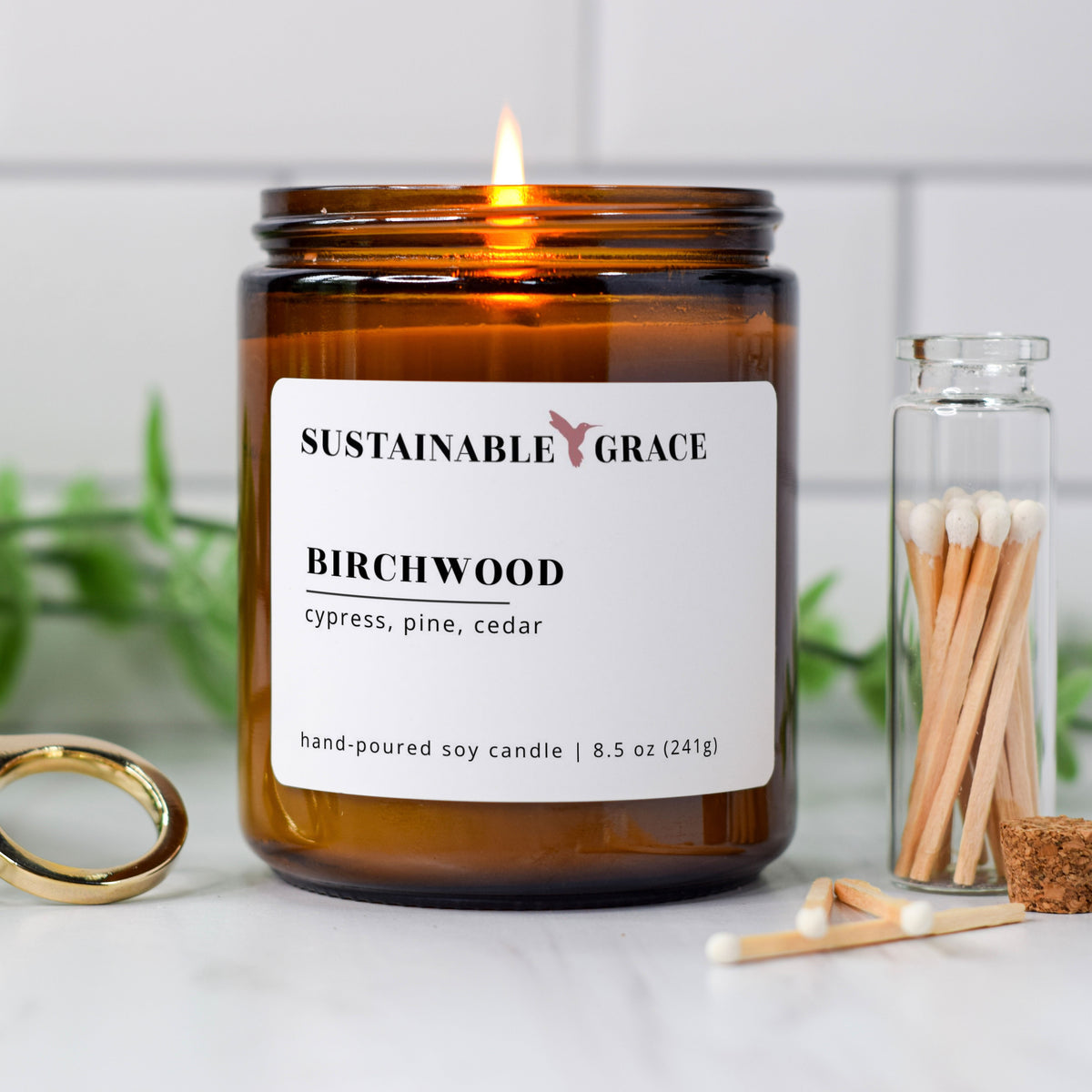 birchwood scented soy candle from sustainable grace in amber colored jar 