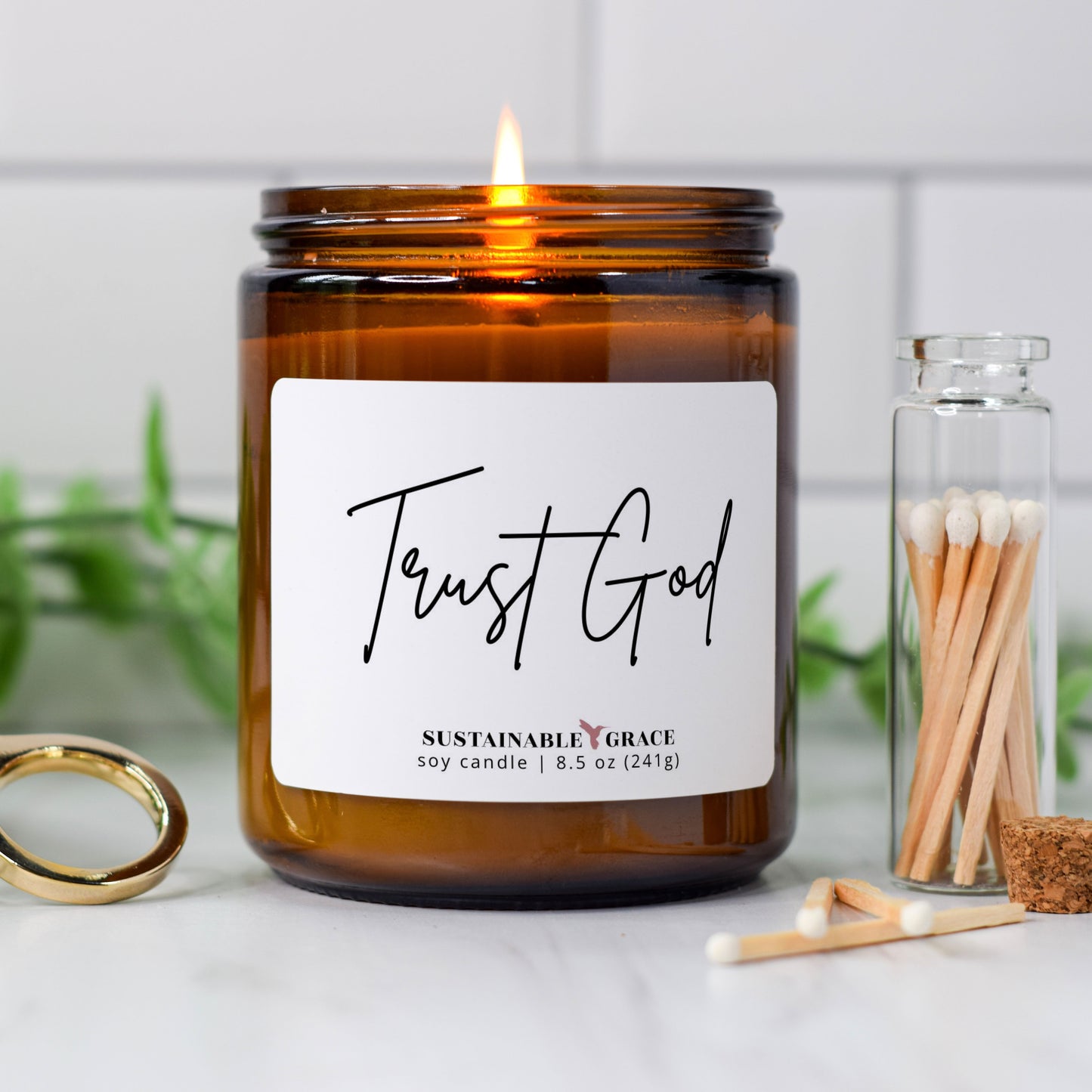 trust God soy candle in amber colored jar 
