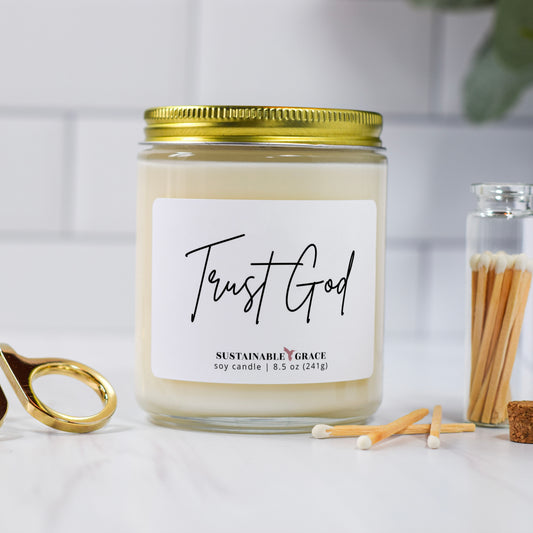 trust god candle with gold lid 