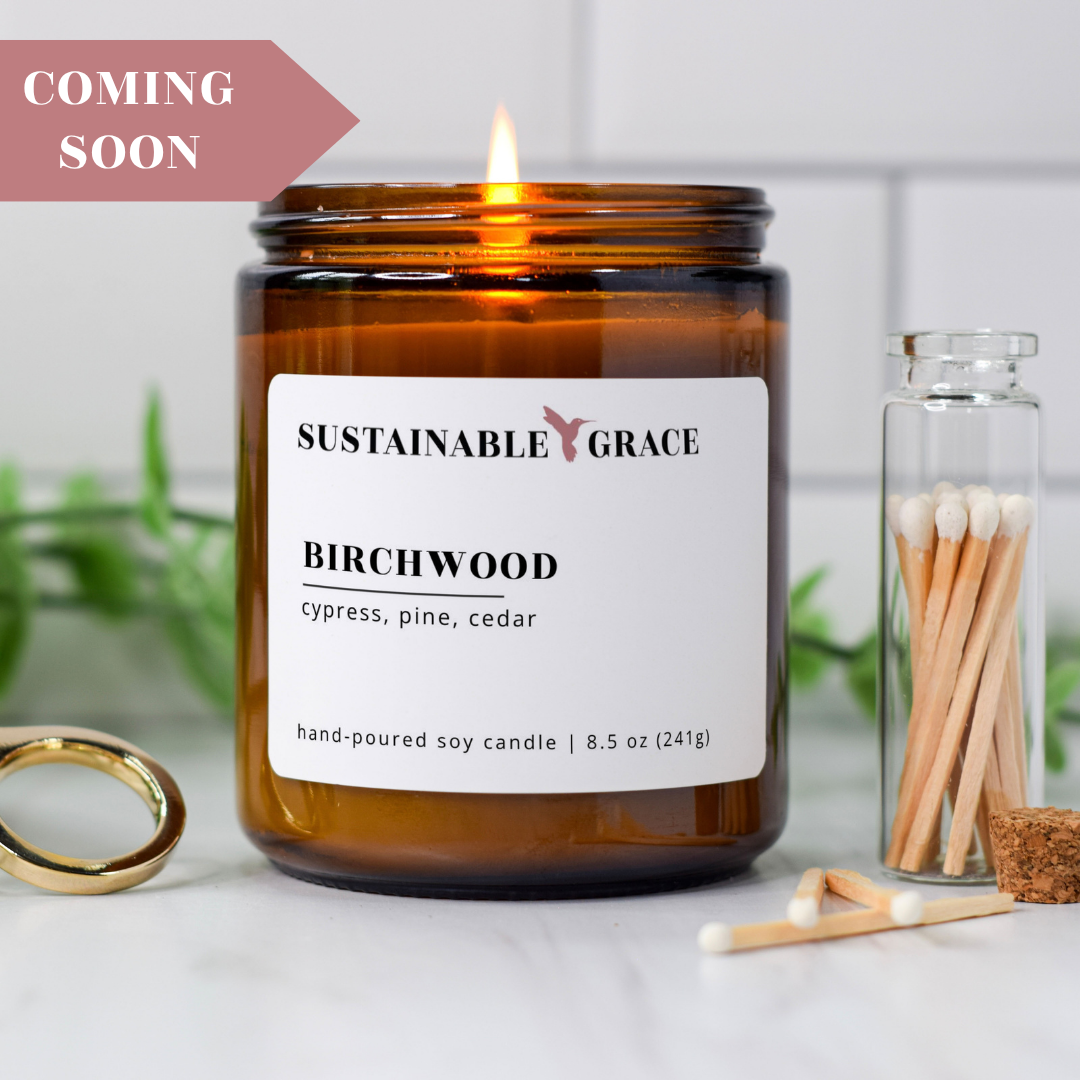 birchwood scented soy candle from sustainable grace in amber colored jar 